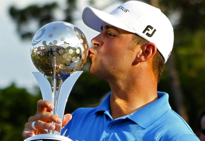Gary Woodland kisses the trophy he won two weeks ago with a victory at the Transitions Championship in Palm Harbor, Fla. Woodland and this blogger went to college together at the University of Kansas, which appears as a good enough reason to throw away money and bet on the field at 12-to-1. 