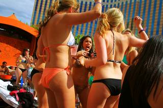 Guests dance to the music from a DJ during opening day for Tao Beach Saturday, April 2, 2011.