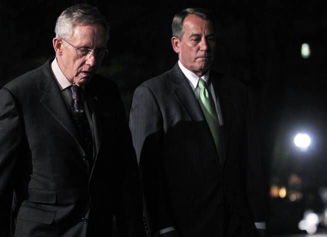House Speaker John Boehner, R-Ohio, and Senate Majority Leader Harry Reid, D-Nev., walk out to speak to reporters after their meeting at the White House in Washington with President Obama regarding the budget and possible government shutdown, Wednesday, April 6, 2011.