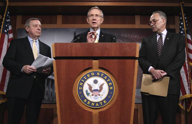 Senate Majority Leader Harry Reid, center, flanked by Senate Majority Whip Richard Durbin of Ill., left, and  Sen. Charles Schumer, D-N.Y., chairman of the Democratic Policy Committee, gestures during a news conference on Capitol Hill in Washington, Thursday, April 7, 2011.