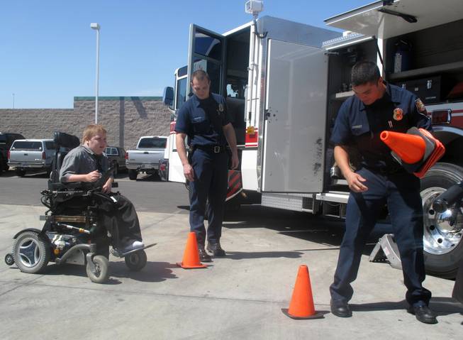 Henderson firefighters set up an obstacle course for 11-year-old Kyle Preston, who has Duchenne muscular dystrophy. Kyle and his brother, Ian, attended the kickoff of the 52nd annual Fill-the-Boot campaign, which benefits the Muscular Dystrophy Association.