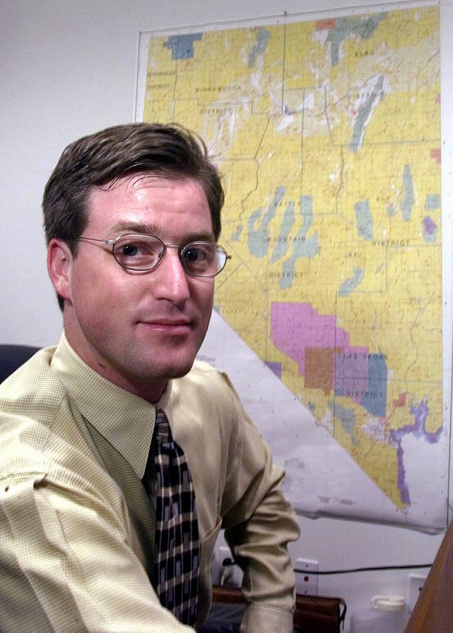 Nevada Mining Association representative Tim Crowley sits in front of a state map Tuesday, February 15, 2000, in the association's Las Vegas office.