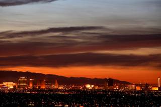 Smoke from the brush fire just east of UNLV's Sam Boyd Stadium makes for a nice sunset over the Las Vegas Strip Saturday, April 16, 2011.