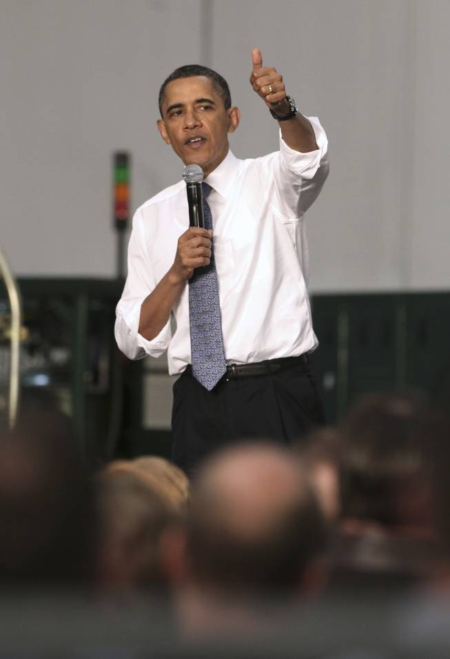 President Barack Obama gestures while addressing the crowd during a town hall meeting at  ElectraTherm, Inc. a small renewable energy company  in Reno, Thursday, April 21, 2011.  