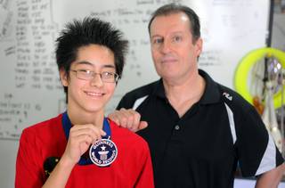 Tyler Tojo Fifield, a 13-year-old North Las Vegas boy, poses with his juggling coach and step-father Dick Franco in their North Las Vegas home on April 21, 2011. 