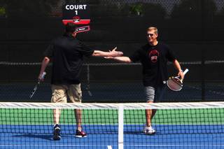 UNLV basketball coach Dave Rice (left) and football coach Bobby Hauck give each other high-fives during an exhibition tennis match with NCAA doubles champion Tim Blenkiron and one of his students, 10-year-old Jack Hambrook, at the Fertitta Tennis Complex on the UNLV campus Saturday, April 23, 2011.