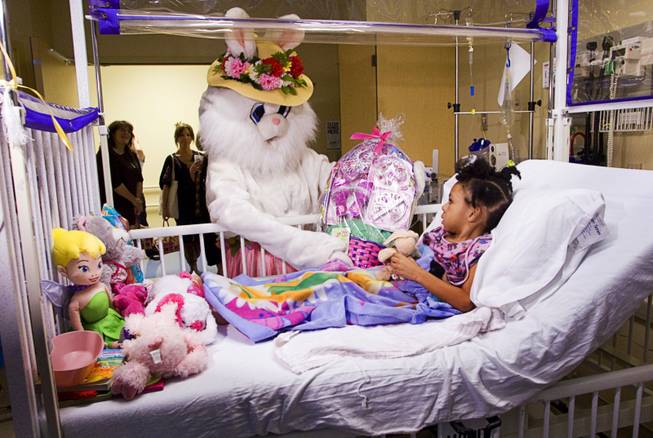 The Easter Bunny delivers a basket to Denysha Clark, 3, at Sunrise Children's Hospital Sunday, April 24, 2011. The visit was courtesy of E-BUNNY, a volunteer organization that provides Easter baskets to disadvantaged children in the Las Vegas Valley.