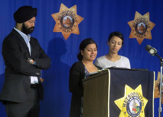 Amandeep Kaur, center, pleads for people to come forward with information about the murder of her husband, Amanpreet Singh. The business owner and father of two young boys was shot to death March 30  outside a Wells Fargo Bank near Sunset Road and Eastern Avenue. His family donated $5,000 to Crime Stoppers on Tuesday in hopes of generating more tips.