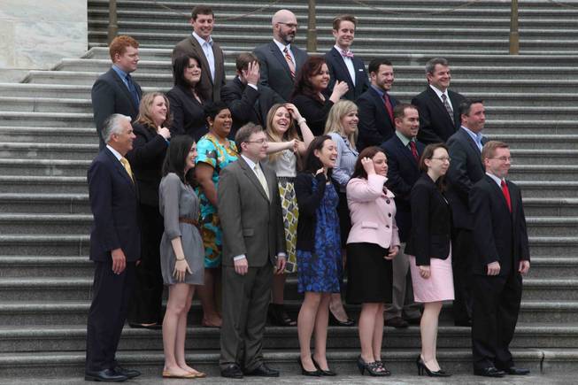 Sen. John Ensign and his staff share a laugh between office photographs on the steps of the Senate at the Capitol in Washington, D.C., on Thursday, April 28, 2011.