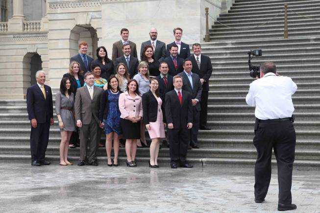 Sen. John Ensign and his staff pose for office photographs on the steps of the Senate at the Capitol in Washington, D.C., on Thursday, April 28, 2011.