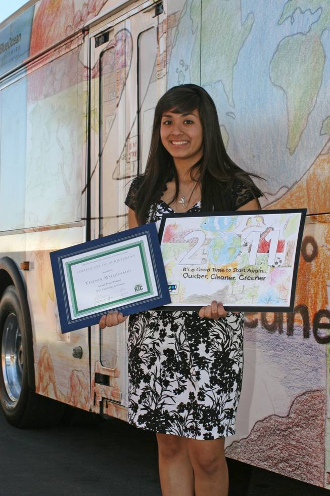 Yesenia Maldonado, 17, of West Preparatory School, poses in front of a bus with her art on the side after winning the RTC's Earth Day contest.