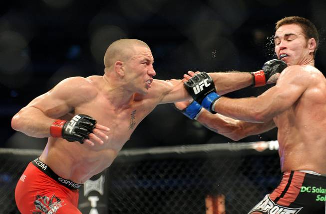 Georges St. Pierre, left, battles against Jake Shields during the welterweight championship match at UFC 129 in Toronto on Saturday, April 30, 2011.