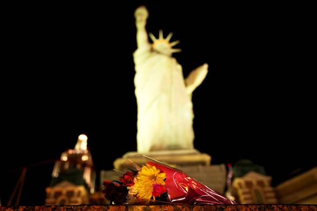 Flowers are left in front the Statue of Liberty at ...