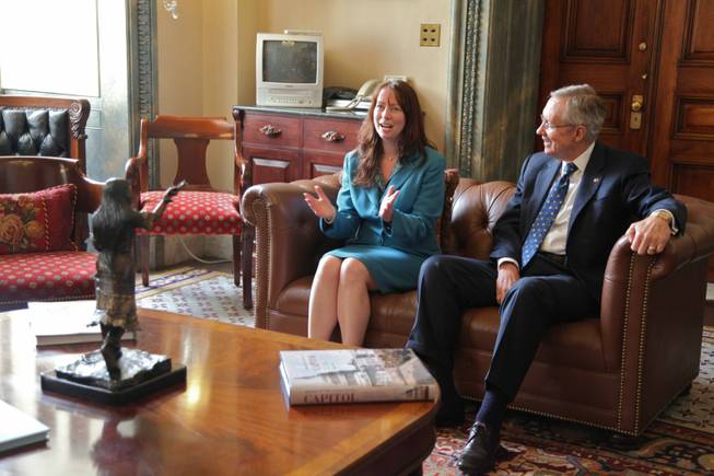 Carson High School English teacher Cheryl Macy, recognized as Nevada's top educator for 2011, meets with Senate Majority Leader Harry Reid on Tuesday in his office in the Capitol Building.