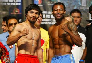 Manny Pacquiao, left, of the Philippines poses with Shane Mosley of Pomona, Calif., during weigh-in at the MGM Grand Garden Arena on Friday, May 6, 2011. Pacquiao will defend his WBO welterweight title against Mosley on Saturday.