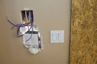 Electrical switches are shown at a foreclosure home in Summerlin Thursday, August 4, 2011. Scott and Aimie Yancey are negotiating to buy the home for their television show 