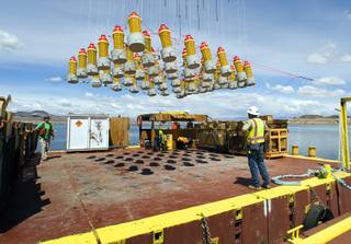 A rig of explosives is lifted by a crane during construction of the the Southern Nevada Water Authority's 
