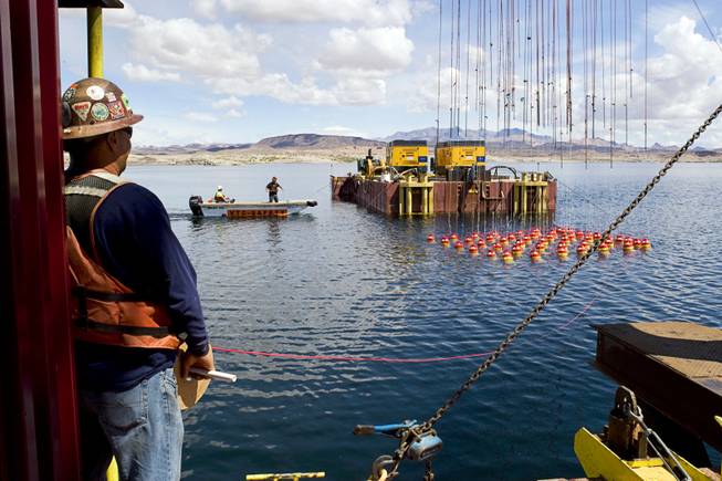 A rig of explosives is lowered into Lake Mead during construction of the Southern Nevada Water Authority's third straw, May 10, 2011. The Vegas Tunnel Constructors crew was blasting a 60-foot shaft in the bottom of the lake for the straw's intake structure.