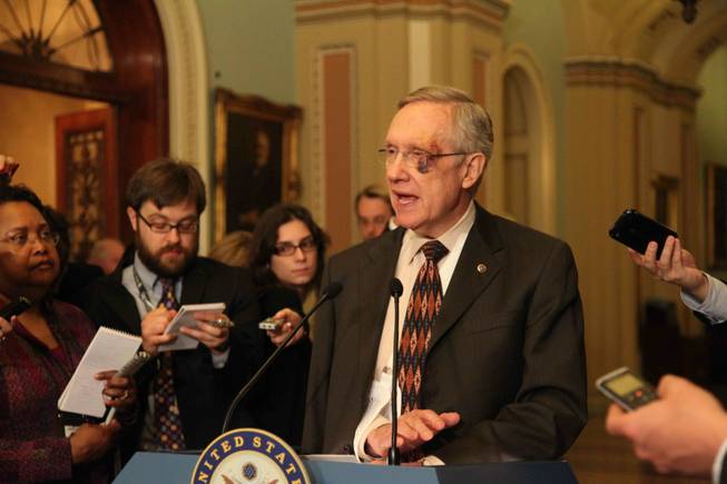 Senate Majority Leader Harry Reid, before a press conference calling for an end to oil company tax breaks, jokes with reporters about his injuries. He said he didn't realize last weekend's Manny Pacquiao fight "was not a black-eye event; it was a black-tie event." Reid slipped and fell in the rain last week while running.