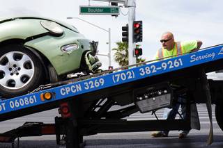 An Ewing Bros. tow operator loads a car onto a tow truck after an accident at Boulder Highway and Tropicana Avenue on Tuesday, May 17, 2011.