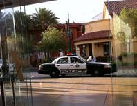 A Metro Police car sits outside the Apple Store at Town Square on Tuesday, May 17, 2011, after, police said, a group of five people entered the store and started stealing iPhones and laptop computers. This photo, ironically, was shot on an iPhone.