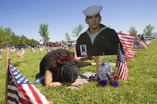 Farideh Ghane grieves at the grave of her son Alexander Ghane after a Memorial Day ceremony at the Southern Nevada Veterans Memorial Cemetery in Boulder City Monday, May 30, 2011. Alexander Ghane, a graduate of Sierra Vista High School and a Navy Seal, was killed during training exercise in 2008.