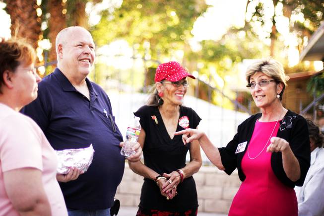 Las Vegas mayoral candidate Chris Giunchigliani, right, talks with supporters Mary Brush, from left, Deray Brush and Mary Joy Alderman during a campaign stop at a downtown barbecue Wednesday, June 1, 2011.