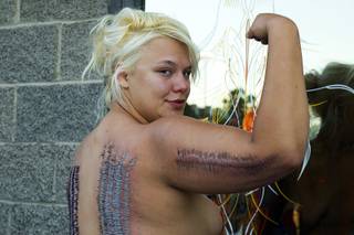 Sideshow performer Staysha Randall poses outside Inktoxicated Tattoos after breaking the Guinness Book record for AuMost Body Piercings in a Single Sitting