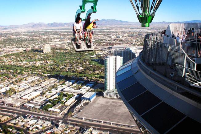 Michael and Jennifer Watkins, of Seattle, ride Insanity at the top of the Stratosphere in Las Vegas on Tuesday, June 7, 2011