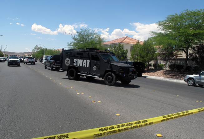 A Metro Police SWAT vehicle prepares to leave the southwest valley neighborhood where a man barricaded himself in a stranger's home while evading arrest. SWAT negotiators later convinced the man to surrender.