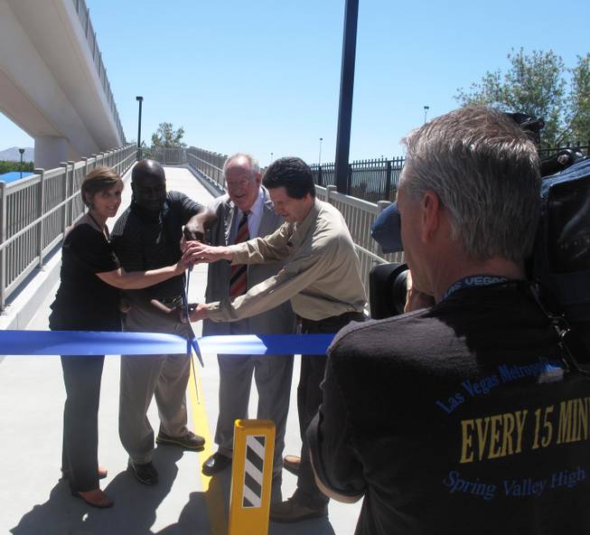 Mayor Oscar Goodman and City Councilman Ricki Barnes help cut the ribbon on the Cultural Corridor Pedestrian Bridge with other project leaders. The bridge will provide more convenient and safe access to several downtown cultural institutions located along Las Vegas Boulevard.