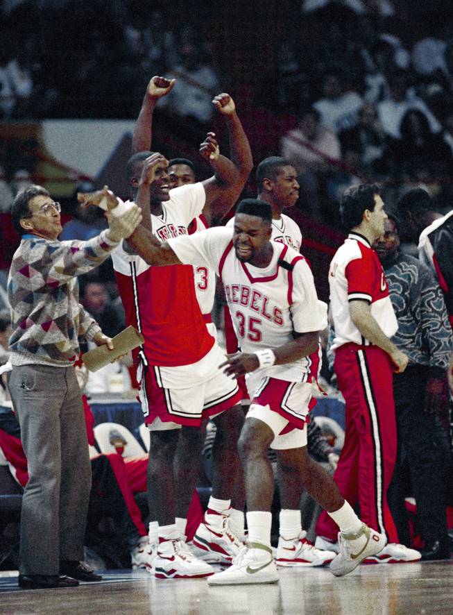 Former UNLV assistant coach Tim Grgurich, far left, celebrates with his players following a 90-81 victory over Georgia Tech in the NCAA tournament's national semifinals on March 31, 1990 in Denver, Colo. Grgurich, who was an aide under Jerry Tarkanian from 1981-92 and a UNLV head coach for seven games in 1994-95 season, won his first title as a long-time NBA assistant on Sunday, as the Dallas Mavericks defeated the Miami Heat, claiming a 4-2 NBA Finals series win.