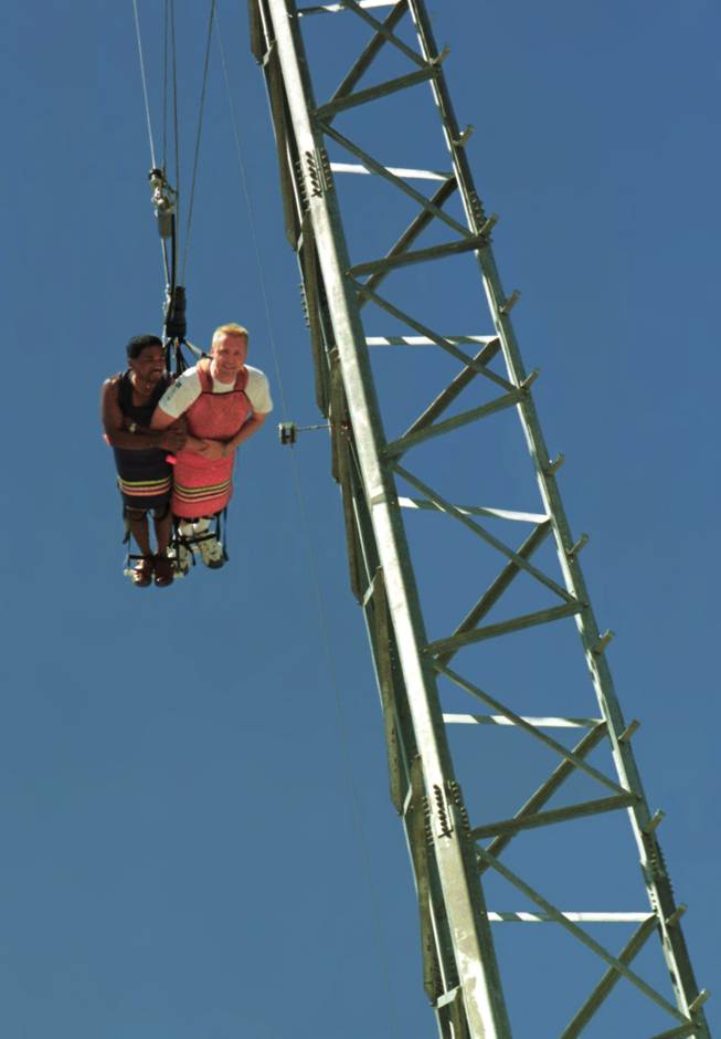 Joe Ramirez, left, and David Reeves, both of Maui, Hawaii, are hoisted to the top of Sky Screamer ride at the MGM Grand Adventures themepark in August 1997.