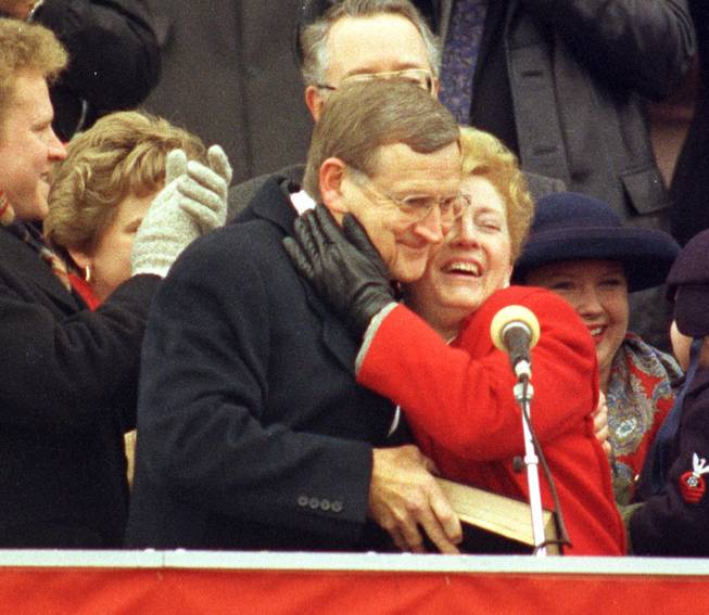 With bible in hand, Missouri Gov. Mel Carnahan is hugged by his wife Jean in Jefferson City, Mo., after being sworn in to his first term as governor in this Jan. 11, 1993 photo. Carnahan, the Democratic candidate in one of the most hotly contested U.S. Senate races in the country, was killed when the plane shuttling him to a campaign rally crashed in rainy, foggy weather. The Cessna 335 also carrying Carnahan's 44-year-old son, Roger, who was piloting the plane, and campaign adviser Chris Sifford, 37, went down Monday night, 25 miles south of St. Louis.