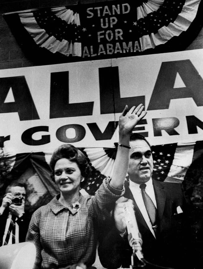 Gov. George Wallace and his wife, Lurleen, stand side-by-side in Birmingham, Ala., March 4, 1966 and acknowledge cheers of an estimated 1,200 persons who attend a rally. The rally launched Mrs. Wallace's candidacy for governor. Wallace said he would be his wife's advisor, if she is elected. 
