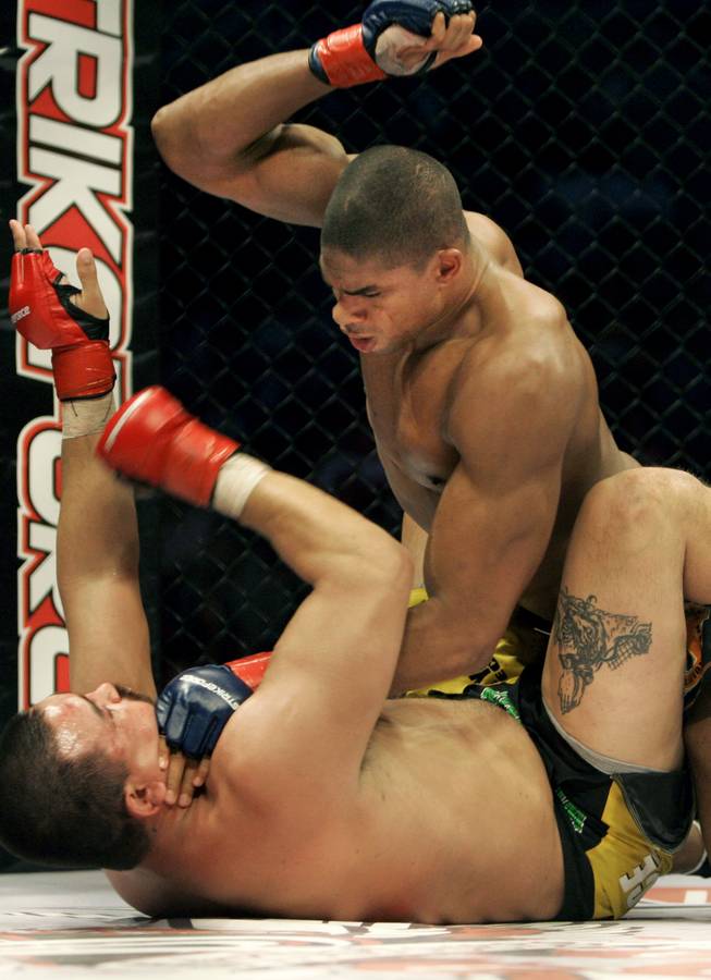 Alistair Overeem, top, punches Paul Buentello in a 2007 Strikeforce heavyweight title fight. Overeem is one of four fighters remaining in the Strikeforce heavyweight tournament.