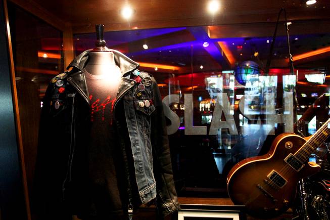 One of Slash's leather jackets, guitars and signature top hats on display at the Hard Rock.