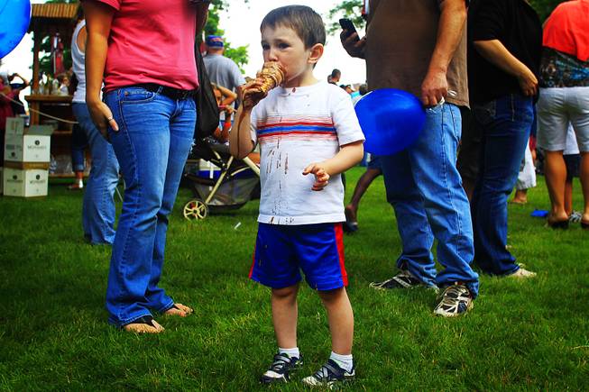 A young boy enjoys an ice cream cone during Party in the Park in Charles City, Iowa.