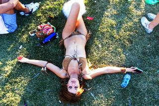 Khristian Olstad lies takes a break on the grass as the sun rises during the Electric Daisy Carnival at the Las Vegas Motor Speedway Sunday, June 26, 2011.