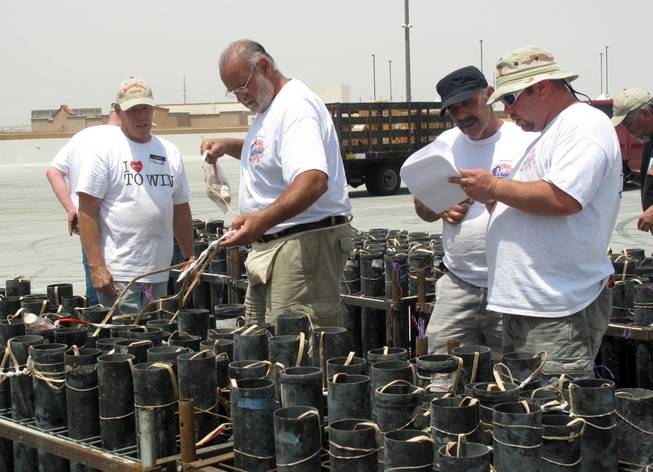 Pyrotechnicians confer about the setup of fireworks for the next day's launch at Texas Station. The fireworks will be part of Station Casinos' "35th Anniversary, 4th of July Blast" at five of its properties in the Las Vegas Valley.