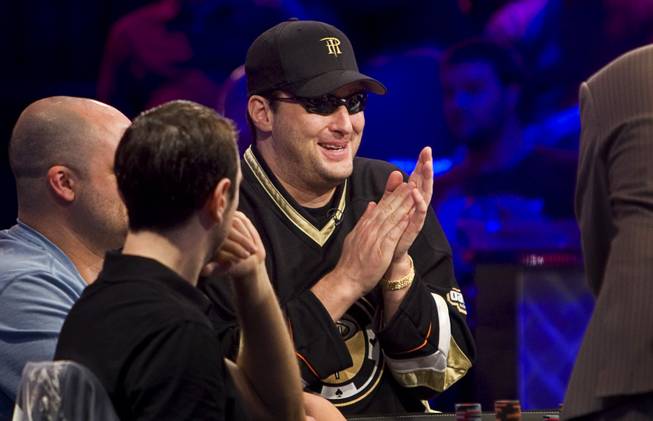 Phil Hellmuth Jr., center, competes at the final table of the $50,000 buy-in, Poker Player's Championship during the World Series of Poker at the Rio Wednesday, July 6, 2011.