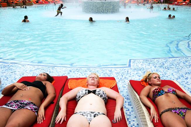 Cassie Yatuni, from left, Christina Elliott and Stephanie Yatuni, all from East Brooklyn, Illinois, lay out at Red Rock Resort pool in Las Vegas Friday, July 8, 2011.