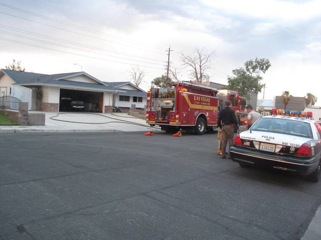The Las Vegas Fire Department and Metro police respond to the scene of a house fire near Rainbow Boulevard and Westcliff Drive where one woman was found dead.