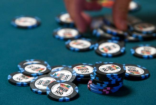 A player stacks chips after winning a hand during the World Series of Poker main event at the Rio Monday, July 11, 2011.