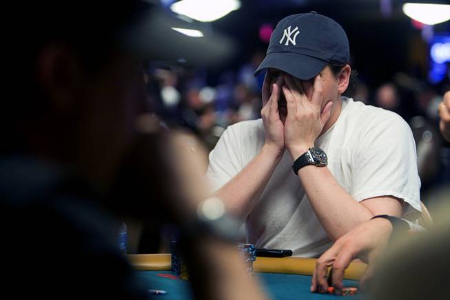 Poker professional Shaun Deeb rubs his face during the World Series of Poker main event at the Rio Monday, July 11, 2011.