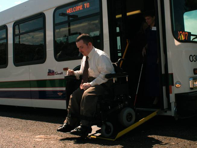 Jason Parker leaves one of the new wheelchair-accessible Metro Transit buses Tuesday, June 3, 2003, after a press conference outside the State Capitol in Oklahoma City, dealing with access for the disabled to public transportation.