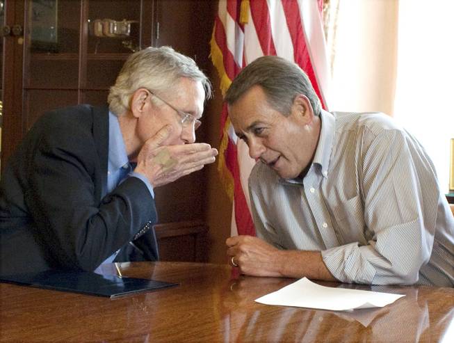 Senate Majority Leader Harry Reid, D-Nev., whispers to House Speaker John Boehner, R-Ohio, in the House Speaker's office before a meeting on the debt limit increase in Washington on Saturday, July 23, 2011. The pair will co-chair a new think tank at UNLV.