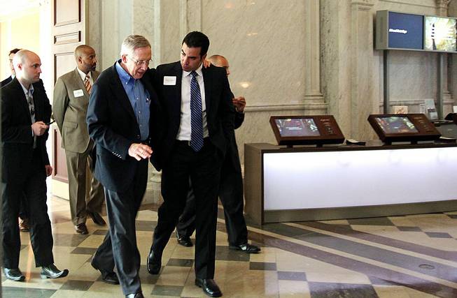 Senate Majority Leader Harry Reid walks out of a luncheon for Nevada lawmakers visiting Washington, D.C., at the Library of Congress with his arm around State Sen. Ruben Kihuen on Saturday, July 23, 2011.