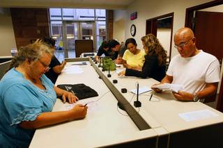 People fill out paperwork at the Civil Law Self Help Center in the Regional Justice Center Thursday, July 28, 2011.