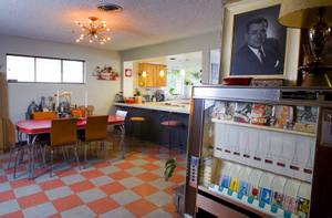 The dining room is shown in the home of Courtney Mooney and Josh Rogers Sunday, July 31, 2011. At right is an old cigarette  vending machine. At top right is a portrait of Jack Cortez who used to publish "Fabulous Las Vegas," a weekly magazine promoting events, entertainment and activities in Las Vegas. The magazine was published from the late 1940s to the early '70s although Jack Cortez died in 1967.